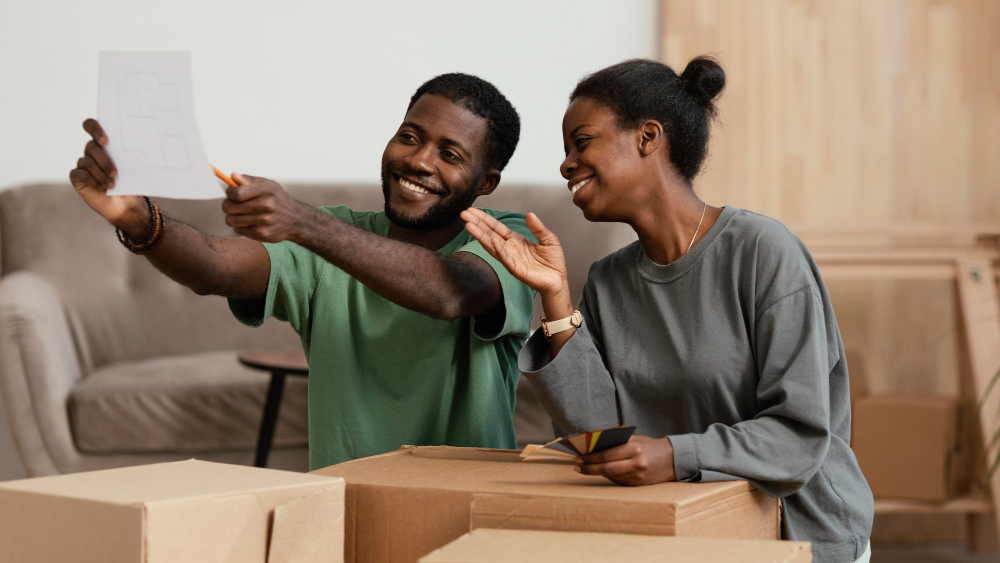 couple making plans in new home with cardboard boxes